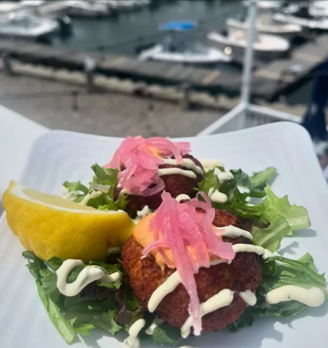 Crab cakes with pickled onion garnish