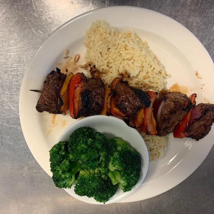 Steak kebab with rice and broccoli